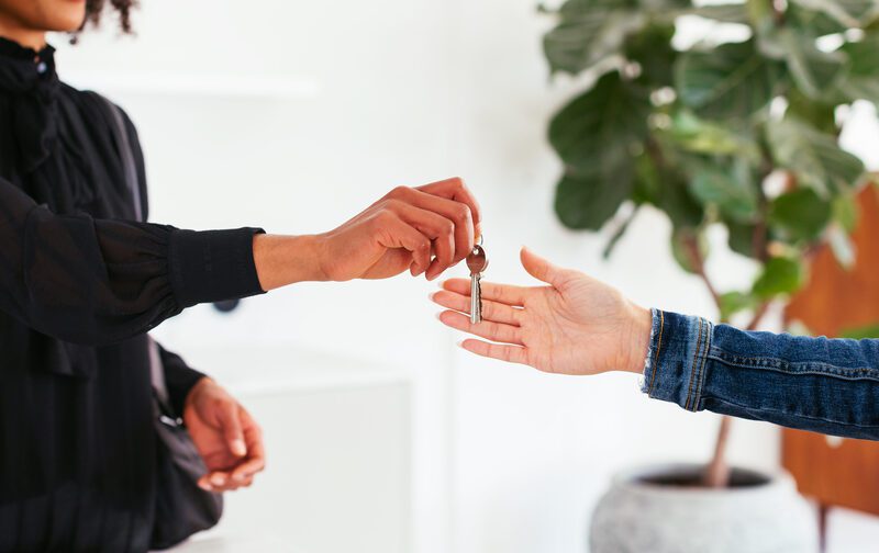 a real estate agent handing over the keys to a new homeowner