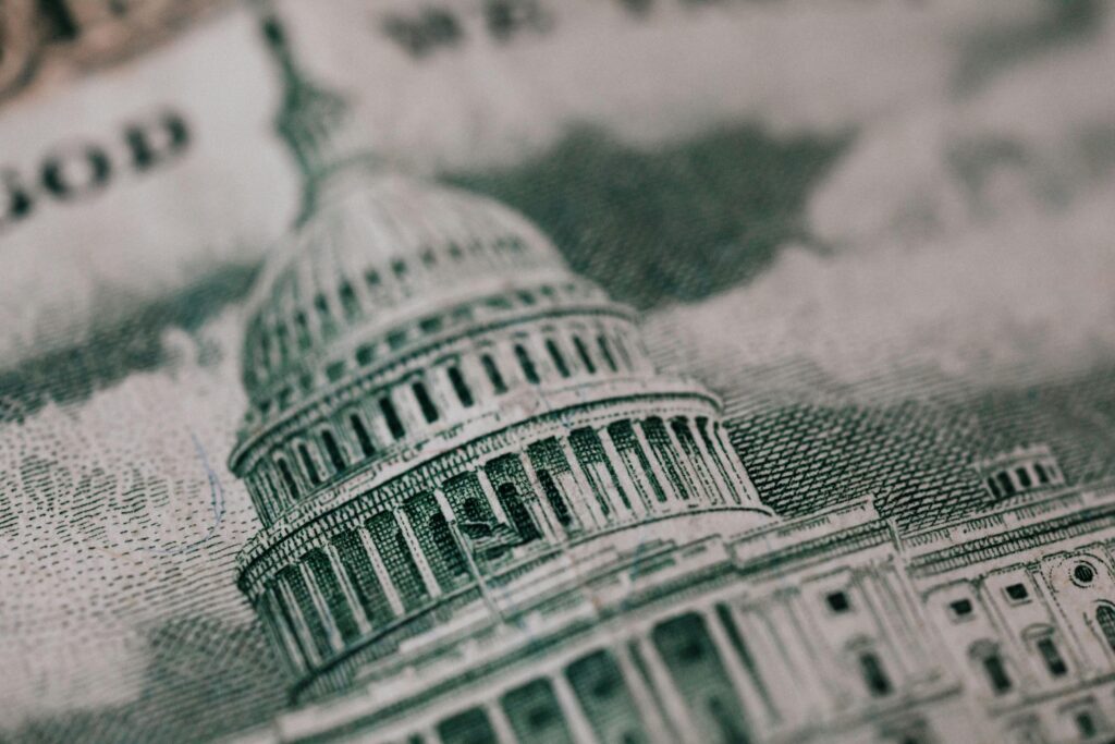 A close-up of an American banknote featuring a historic building—symbolizing federal estate tax laws and the financial implications of not leveraging estate tax exemption portability for married couples.