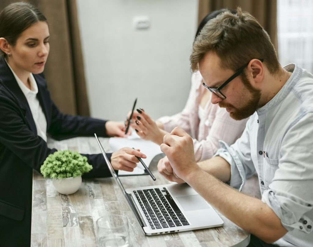 A bearded man working intently on a laptop—symbolizing the detailed analysis needed to optimize portfolio structure for tax efficiency.
