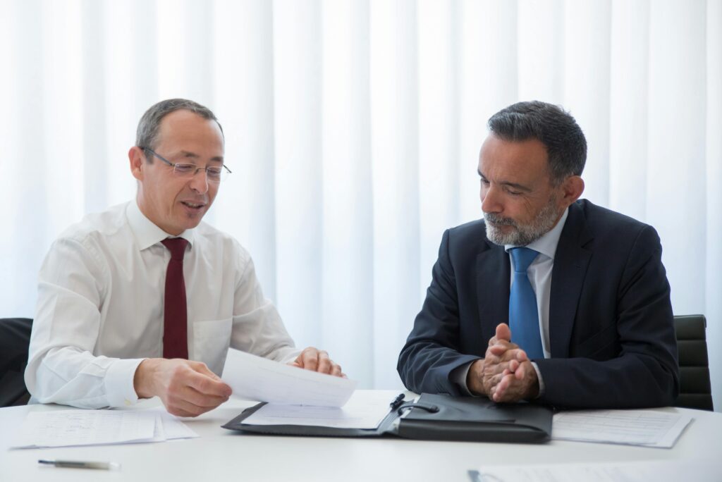 Professional tax advisor discussing strategies with a client in a business setting.