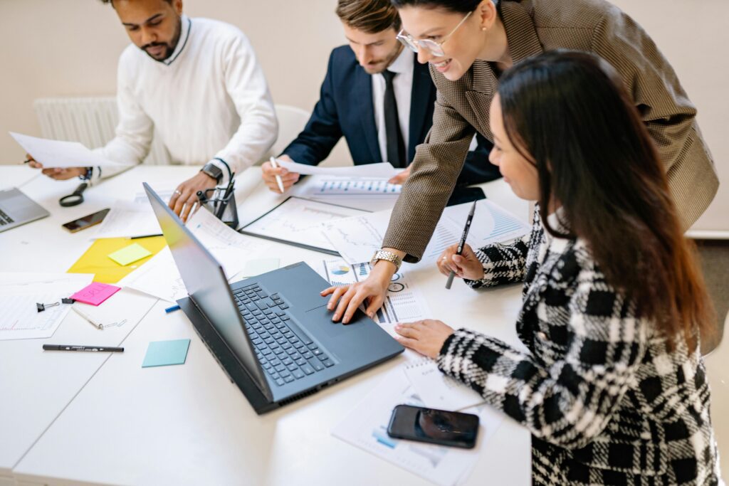 Colleagues discussing tax strategies around a conference table, emphasizing collaboration in financial planning for the SALT deduction limit in 2025.