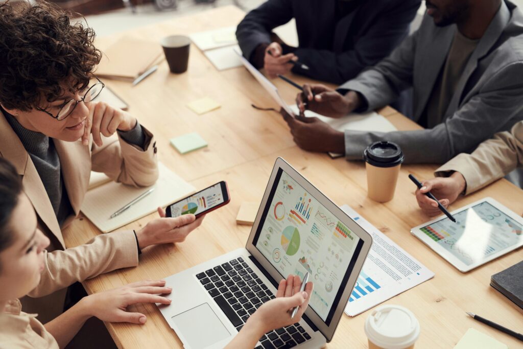 People gathered around a table discussing technology integration.