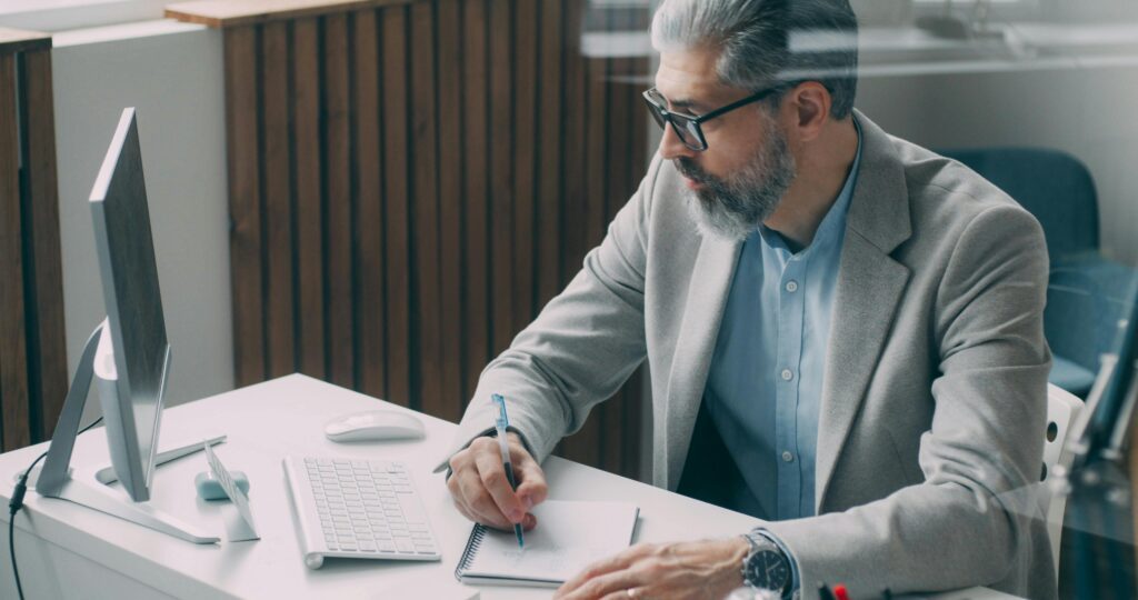 A man reading documents at his desk.