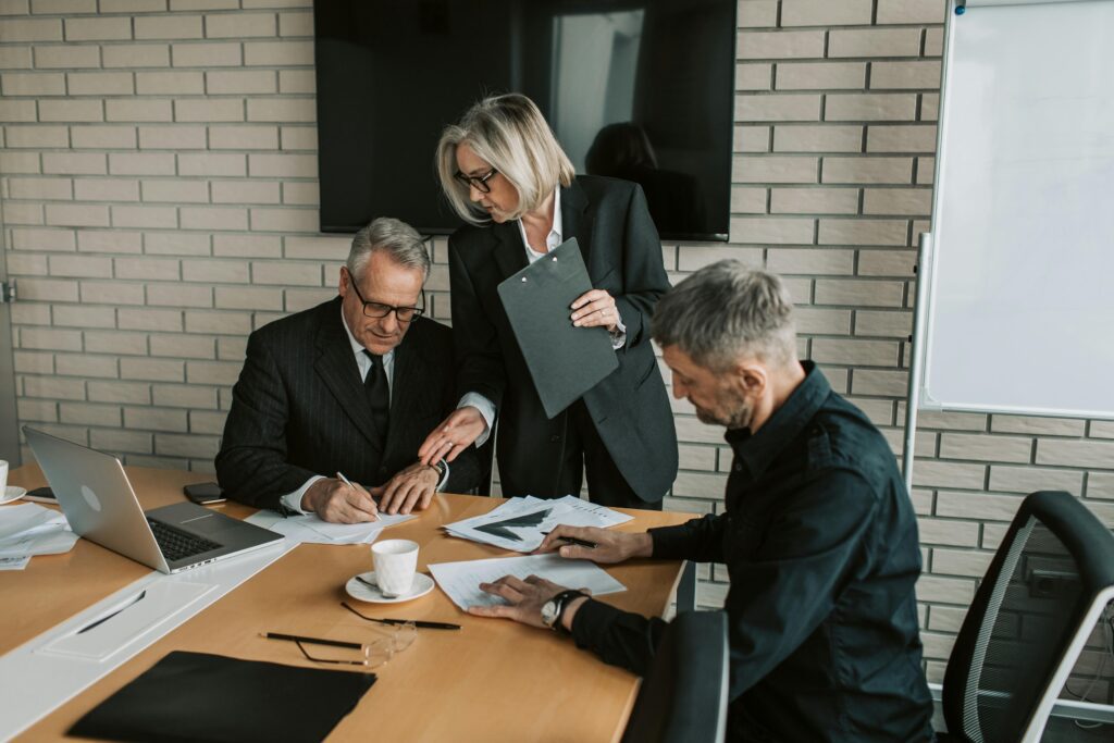 A man signing documents, symbolizing business succession planning.